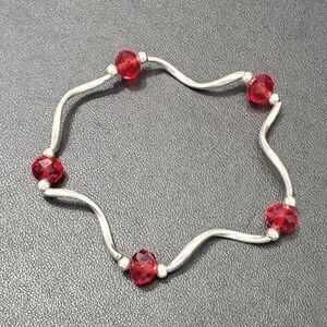 Swirly silver tone and red bead stretch bracelet 7.25"